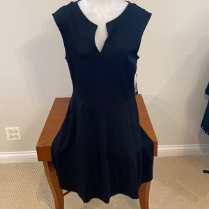Adorable black knit flare dress with pockets. NWT